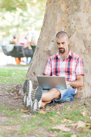 Young Man With Computer at Parkの写真素材
