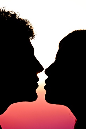 Young Couple Silhouette at Sunsetの写真素材