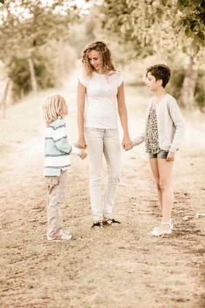 Beautiful Young Woman with Two Children Outsideの写真素材