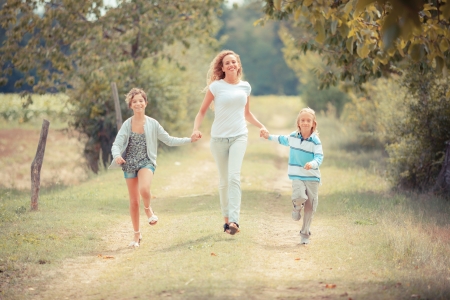 Beautiful Young Woman with Two Children Outsideの写真素材