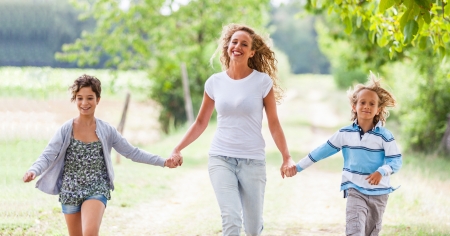 Beautiful Young Woman with Two Children Outsideの写真素材