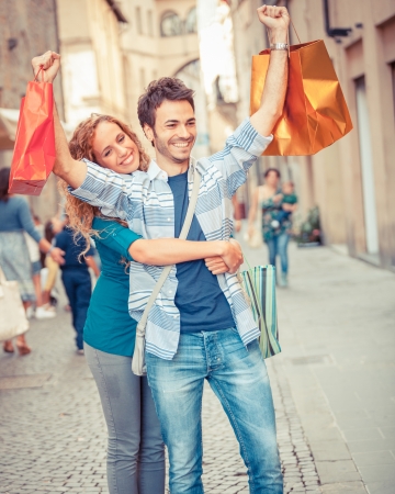 Happy Young Couple with Shopping Bagsの写真素材