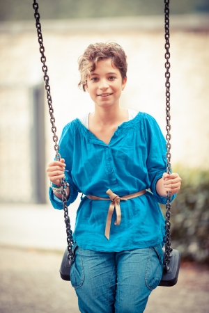 Young Girl Playing on the Swingの写真素材