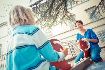 Happy Children Playing at Playgroundの写真素材