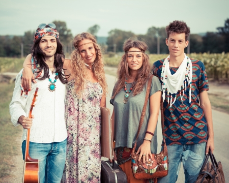Hippie Group Walking on a Countryside Roadの写真素材