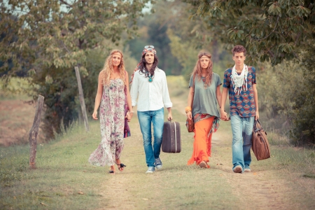 Hippie Group Walking on a Countryside Roadの写真素材