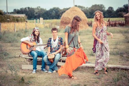 Hippie Group Playing Music and Dancing Outsideの写真素材