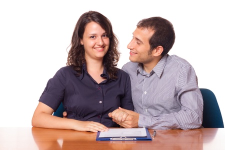 Happy Young Couple with Important Document to Signの写真素材