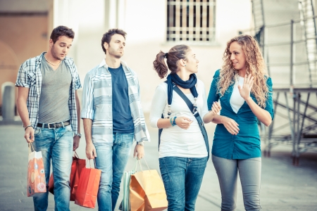 Happy Girls With Bored Boys on Shoppingの写真素材