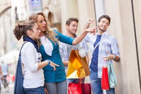 Happy Girls With Bored Boys on Shoppingの写真素材