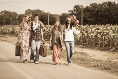 Hippie Group Walking on a Countryside Roadの写真素材