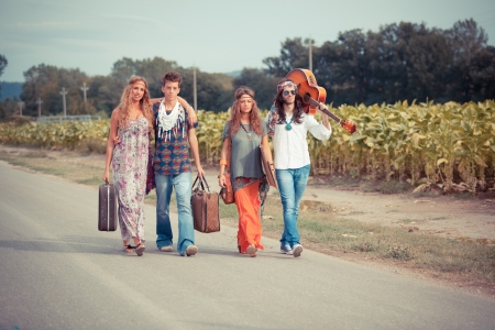 Hippie Group Walking on a Countryside Roadの写真素材