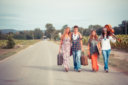 Hippie Group Walking on a Countryside Roadの写真素材