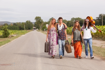 Hippie Group Walking on a Countryside Roadの写真素材