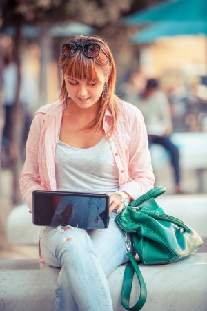 Beautiful Young Woman with Computer Outsideの写真素材