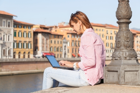 Beautiful Young Woman with Computer Outsideの写真素材