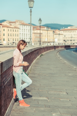 Beautiful Young Woman sending Message with Mobile Phoneの写真素材