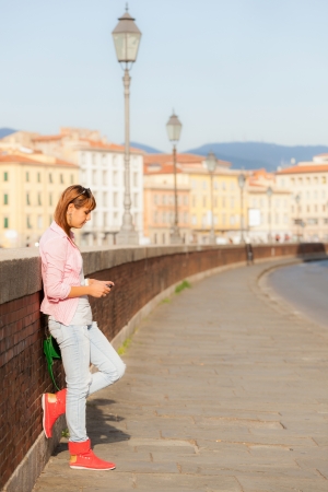 Beautiful Young Woman sending Message with Mobile Phoneの写真素材
