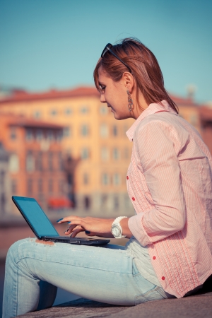 Beautiful Young Woman with Computer Outsideの写真素材