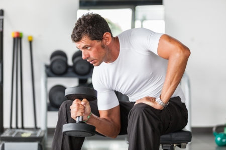 Man Lifting Weights at Gymの写真素材