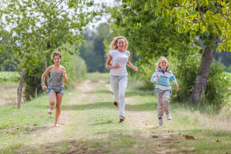 Beautiful Young Woman with Two Children Outsideの写真素材