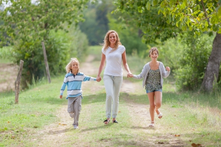 Beautiful Young Woman with Two Children Outsideの写真素材