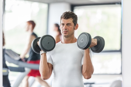 Man Lifting Weights at Gymの写真素材