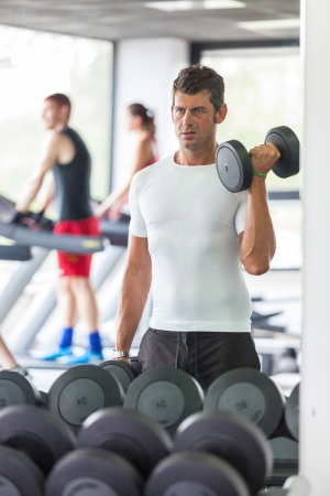 Man Lifting Weights at Gymの写真素材