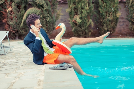 Funny Young Businessman with SwimmingTrunks next to the Poolの写真素材