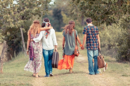 Hippie Group Walking on a Countryside Roadの写真素材