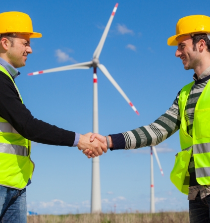 Engineers giving Handshake in a Wind Turbine Power Stationの写真素材