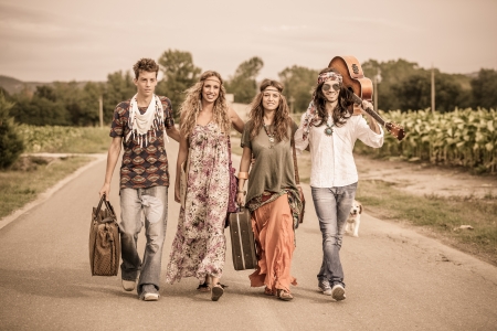 Hippie Group Walking on a Countryside Roadの写真素材