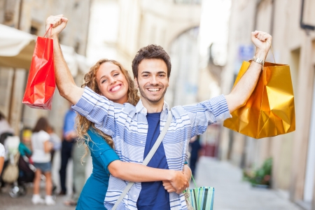 Happy Young Couple with Shopping Bagsの写真素材
