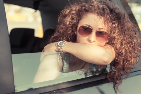 Pensive Girl Looking out of Car Windowの写真素材