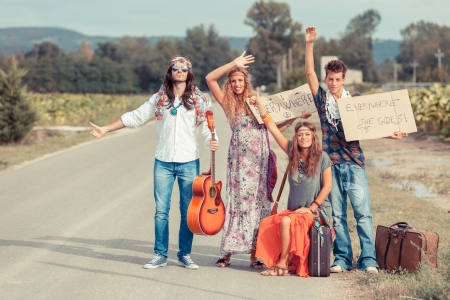 Hippie Group Hitchhiking on a Countryside Roadの写真素材