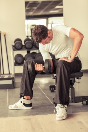 Man Lifting Weights at Gymの写真素材