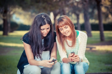 Two Young Women with Mobile Phoneの写真素材