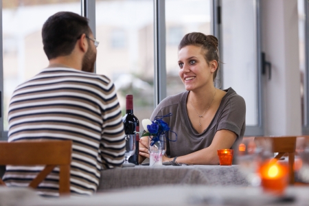 Romantic Young Couple at Restaurantの写真素材
