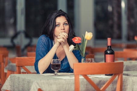 Bored Woman Alone at Restaurantの写真素材