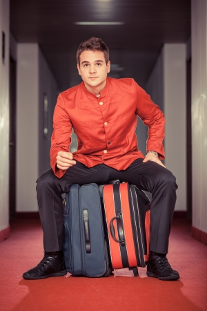Tired Bellboy with Luggagesの写真素材