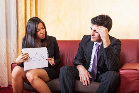 Sad Business Couple on the Sofaの写真素材