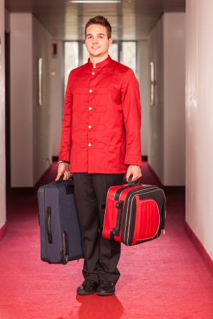 Bellboy with Luggages in the Hallwayの写真素材