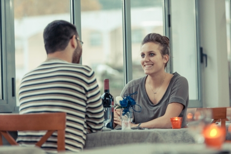 Romantic Young Couple at Restaurantの写真素材