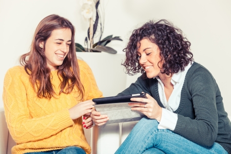 Two Beautiful Women with Digital Tabletの写真素材