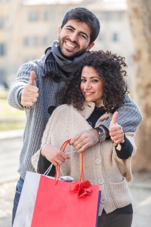 Happy Young Couple with Shopping Bagsの写真素材