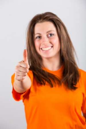 Joyful Young Woman with Thumb Upの写真素材