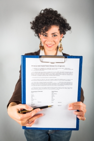 Young Businesswoman Showing a Contract to Signの写真素材