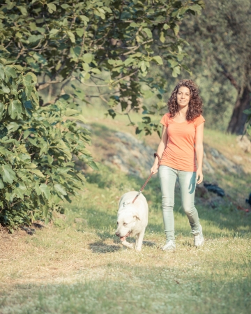 Young Woman Walking with Her Dogの写真素材