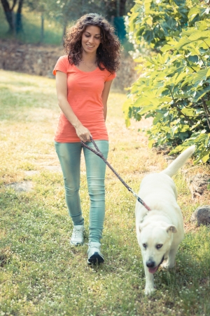 Young Woman Walking with Her Dogの写真素材