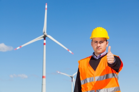 Technician Engineers Thumbs Up with Wind Power Generatorの写真素材